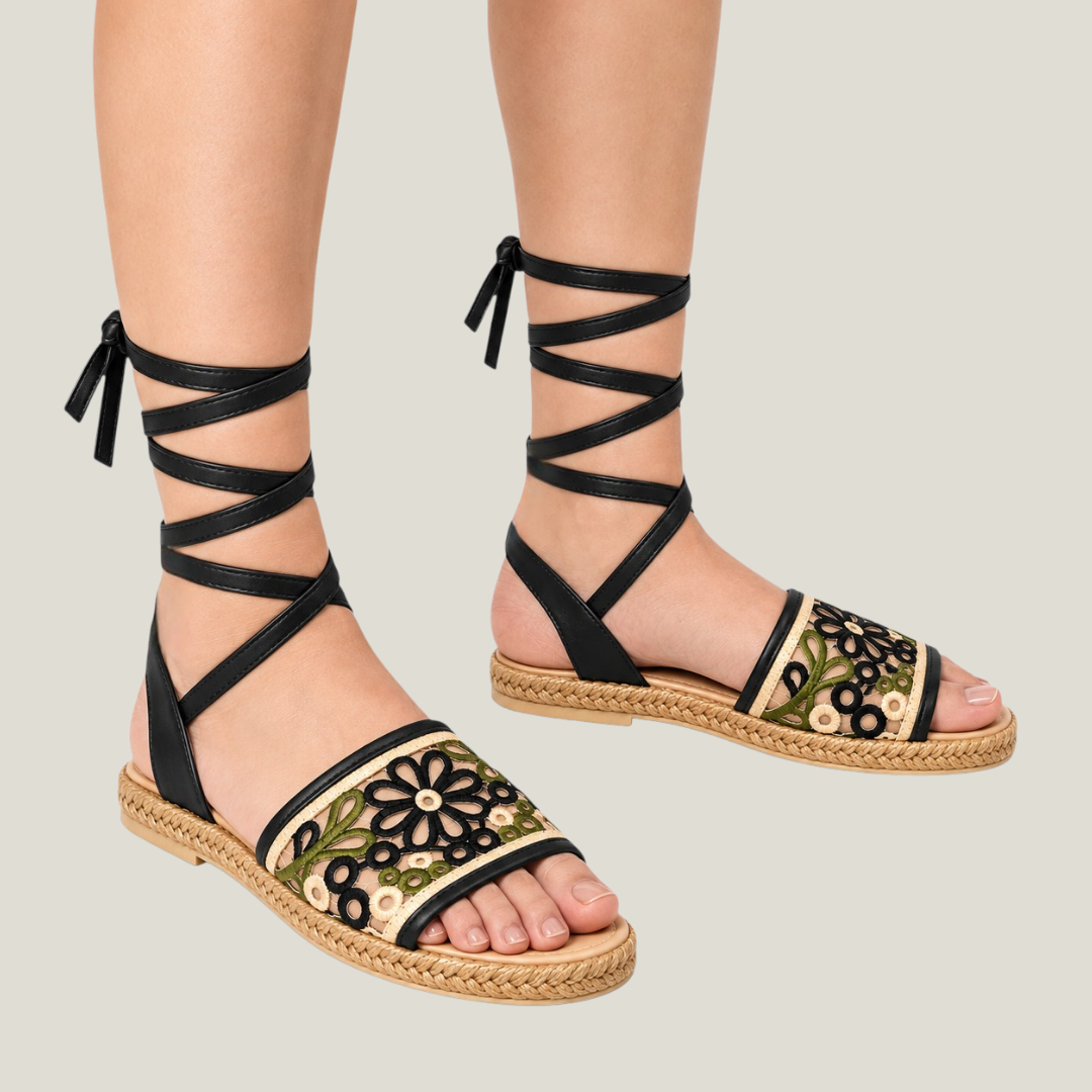 Fiorella black floral lace-up sandals styled on feet