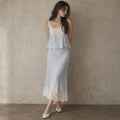 Model wearing powder-blue lace camisole and matching lace-hem midi skirt