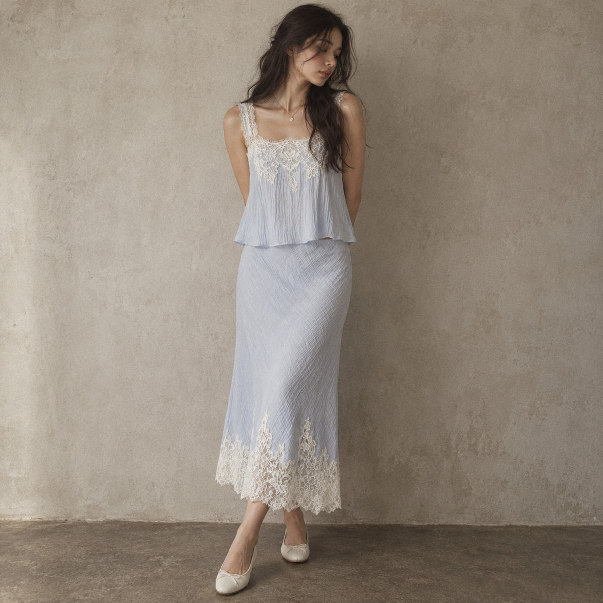 Model wearing powder-blue lace camisole and matching lace-hem midi skirt