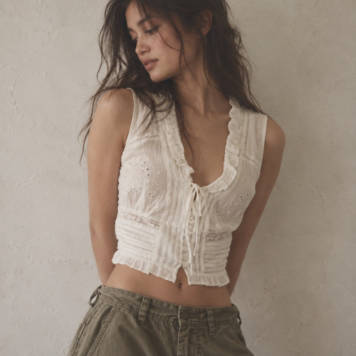 Odette Broderie Top ivory floral eyelet embroidered top with pintucks and ruffled neckline on model