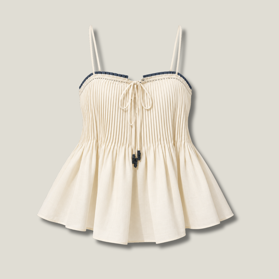 Pleated Cami Ivory front view with fine vertical pleats, contrast trim, front tie and flared peplum